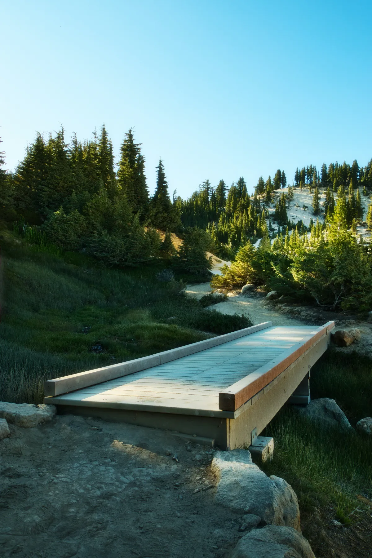 A stone bridge crossing a mountain stream, passage built to endure.